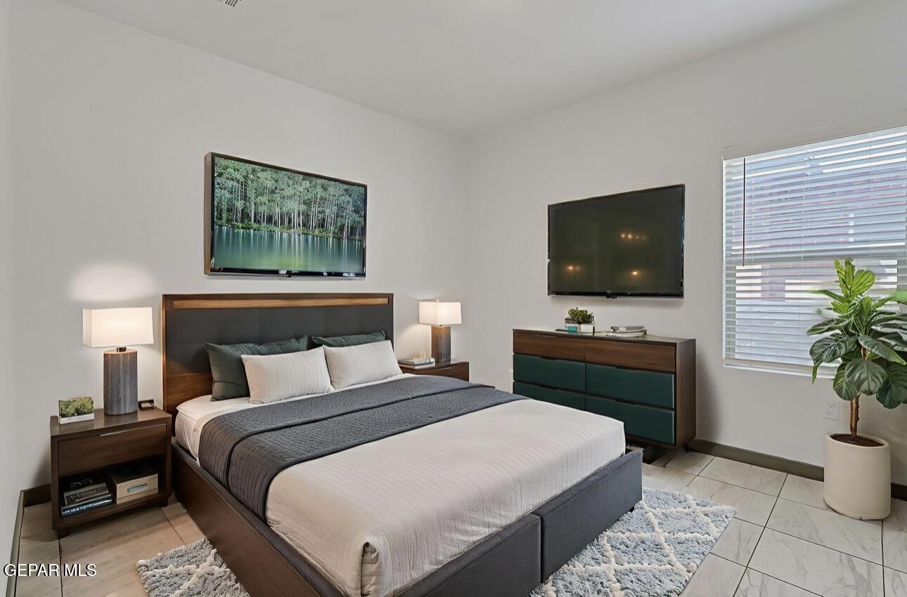 4572 Mark Avizo El Paso, TX 79938 - Photo 12 of 32 a bedroom with a bed and a flat screen tv