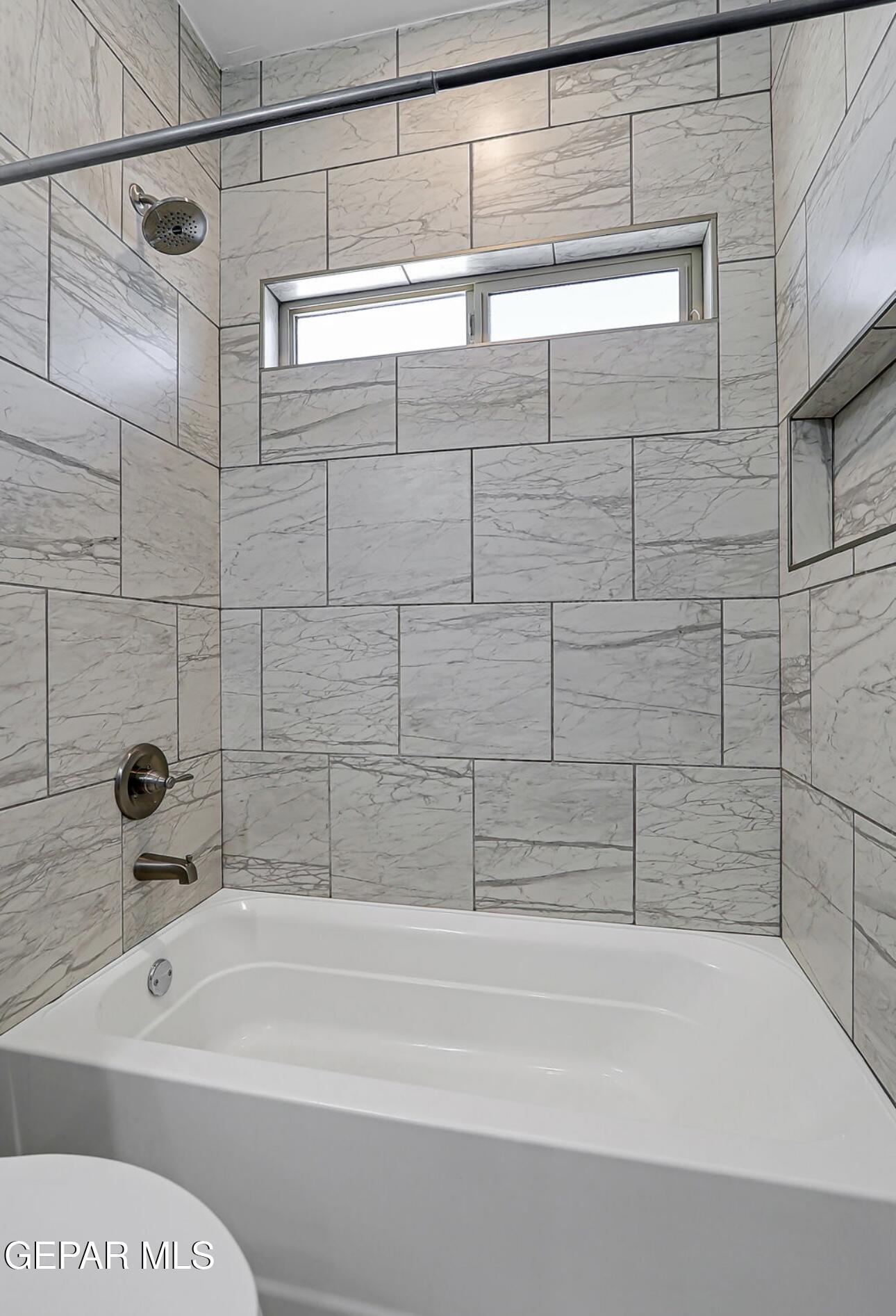 4572 Mark Avizo El Paso, TX 79938 - Photo 15 of 32 a bathroom with a bathtub and shower