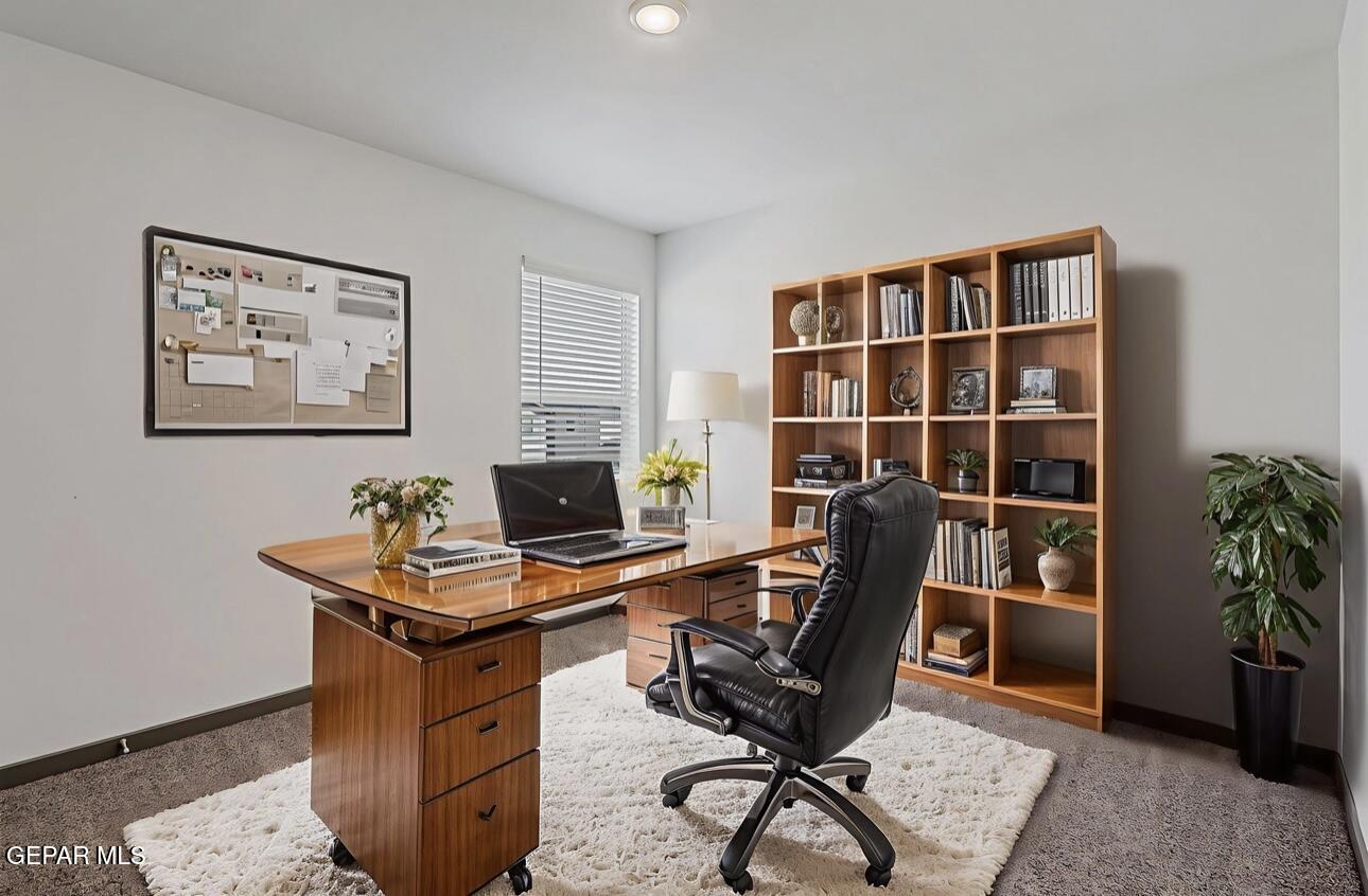 4572 Mark Avizo El Paso, TX 79938 - Photo 19 of 32 a view of a workspace with furniture and a bookshelf
