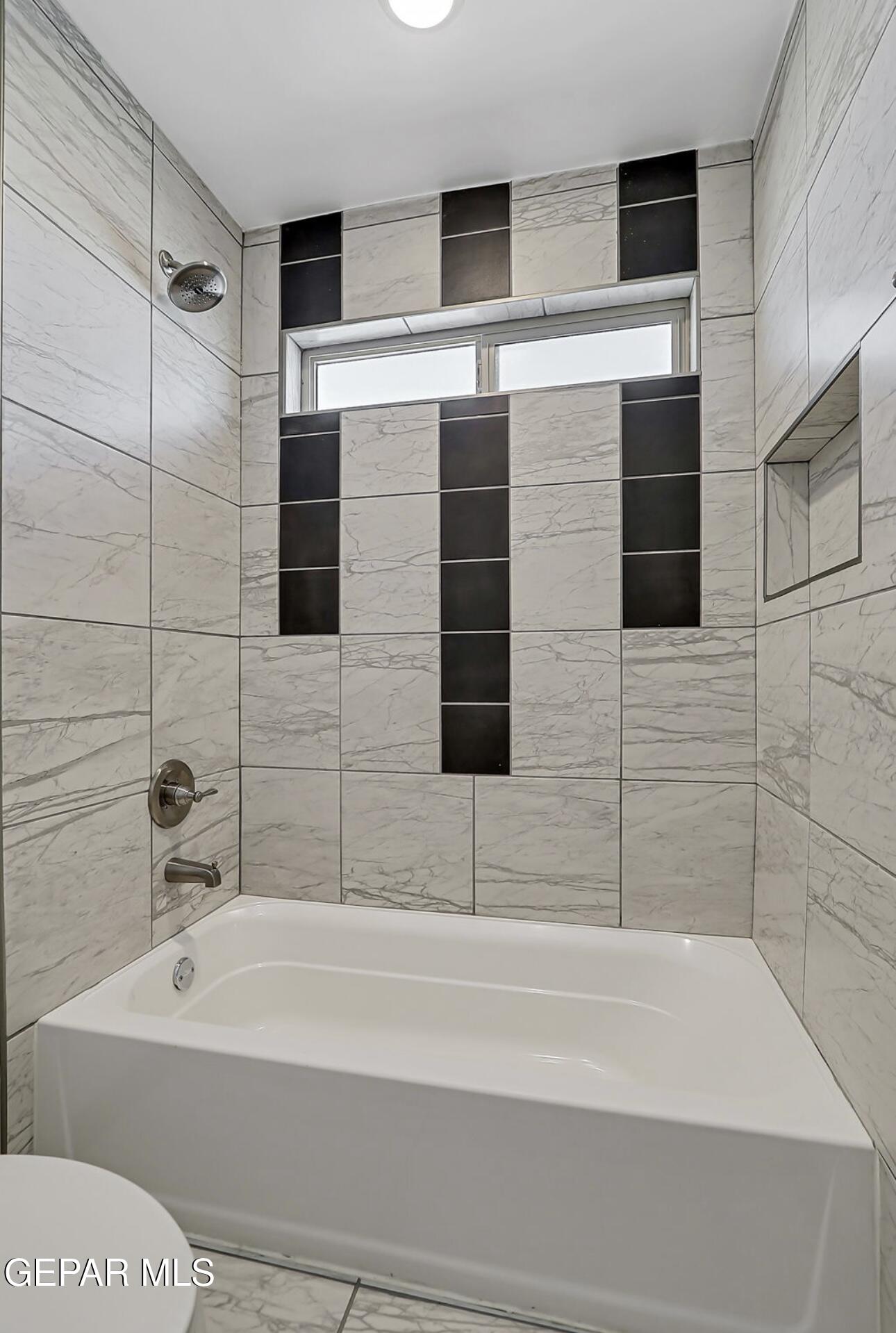 4572 Mark Avizo El Paso, TX 79938 - Photo 22 of 32 a bathroom with a bathtub and shower