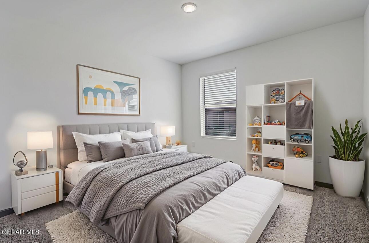 4572 Mark Avizo El Paso, TX 79938 - Photo 23 of 32 a bedroom with a large bed and a couch