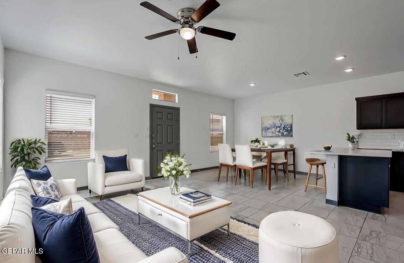 4572 Mark Avizo El Paso, TX 79938 - Photo 10 of 32 a living room with furniture a dining table and a potted plant