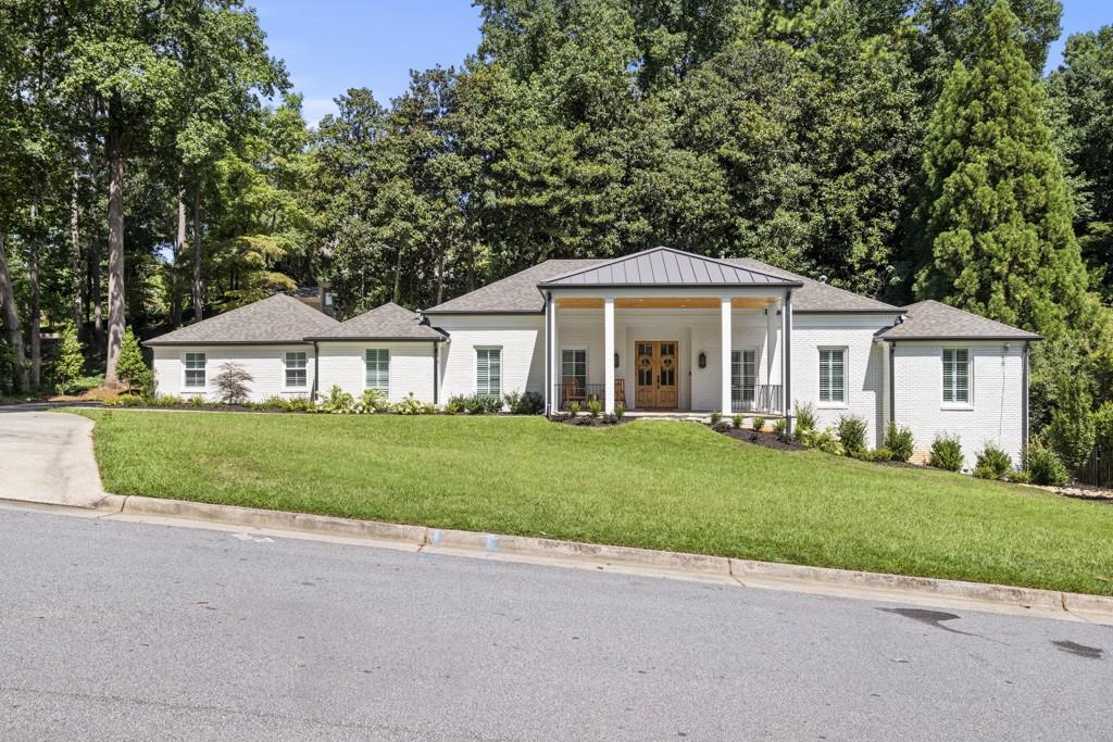 65 Barbara Lane Northwest Atlanta, GA 30327 - Photo 1 of 1 a front view of a house with a yard and garage