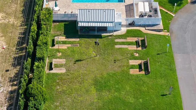 a front view of a house with large windows and plants