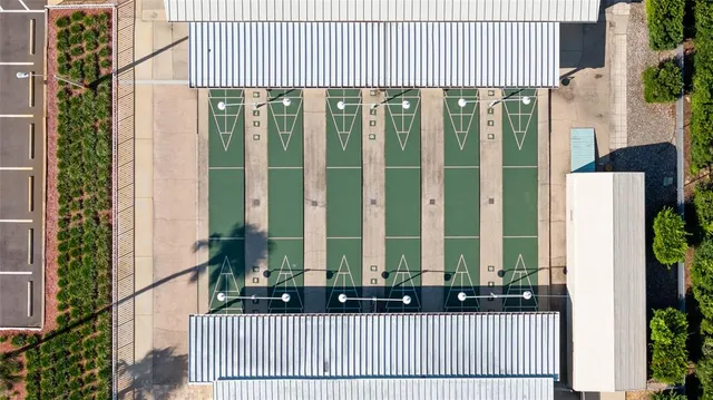 a front view of a building with glass windows and a yard