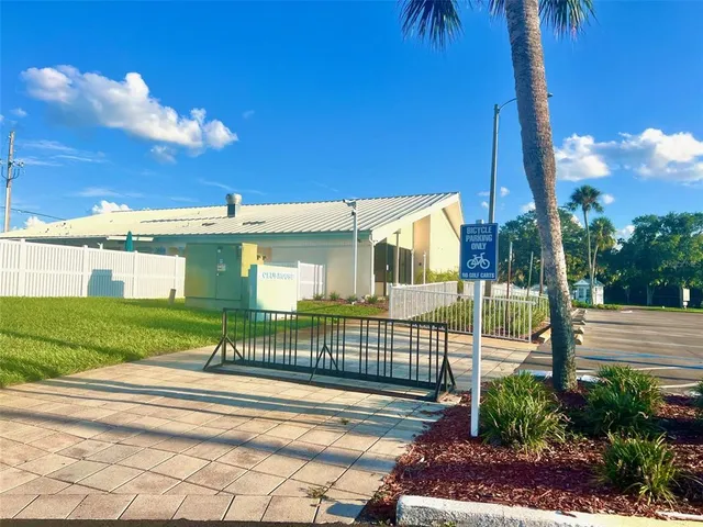 an aerial view of a house with a yard swimming pool and outdoor seating