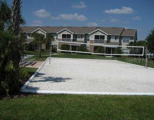 8932 Manor Loop, Unit 208 Lakewood Ranch, FL 34202 - Photo 1 of 1 a front view of a house with a yard