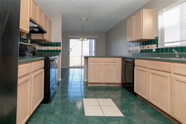 a kitchen with stainless steel appliances granite countertop a refrigerator and a stove
