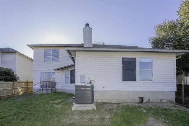 a backyard of a house with table and chairs