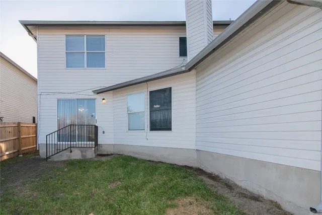 a white toilet sitting next to a white tub