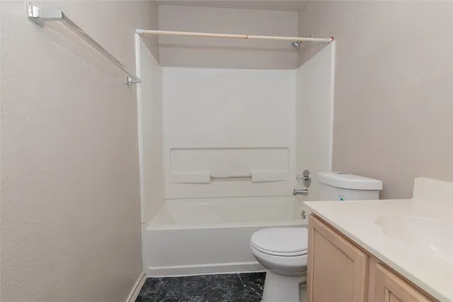 a stone house with trees in front of it