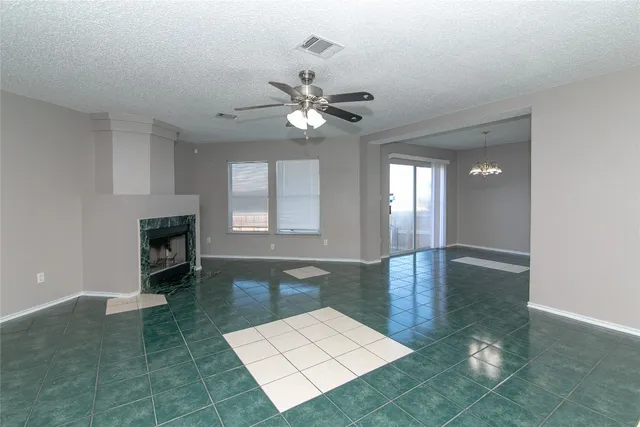 a living room with fireplace furniture and a rug