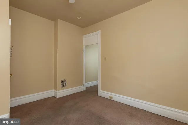 an empty room with closet area