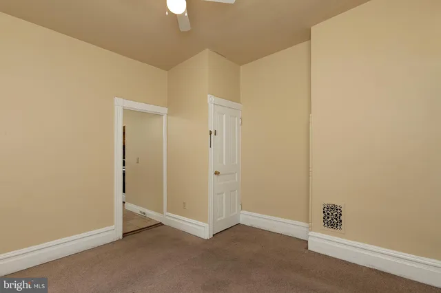 an empty room with closet area