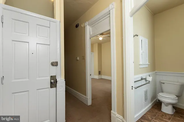 a bathroom with a granite countertop sink a toilet and a shower