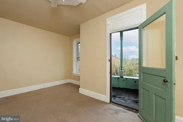 a view of an empty room and a window