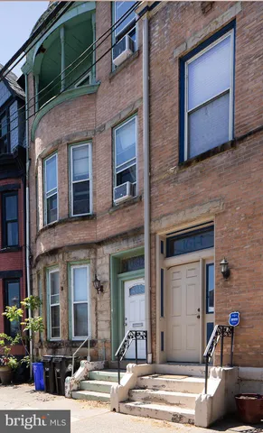 a view of a brick building with many windows