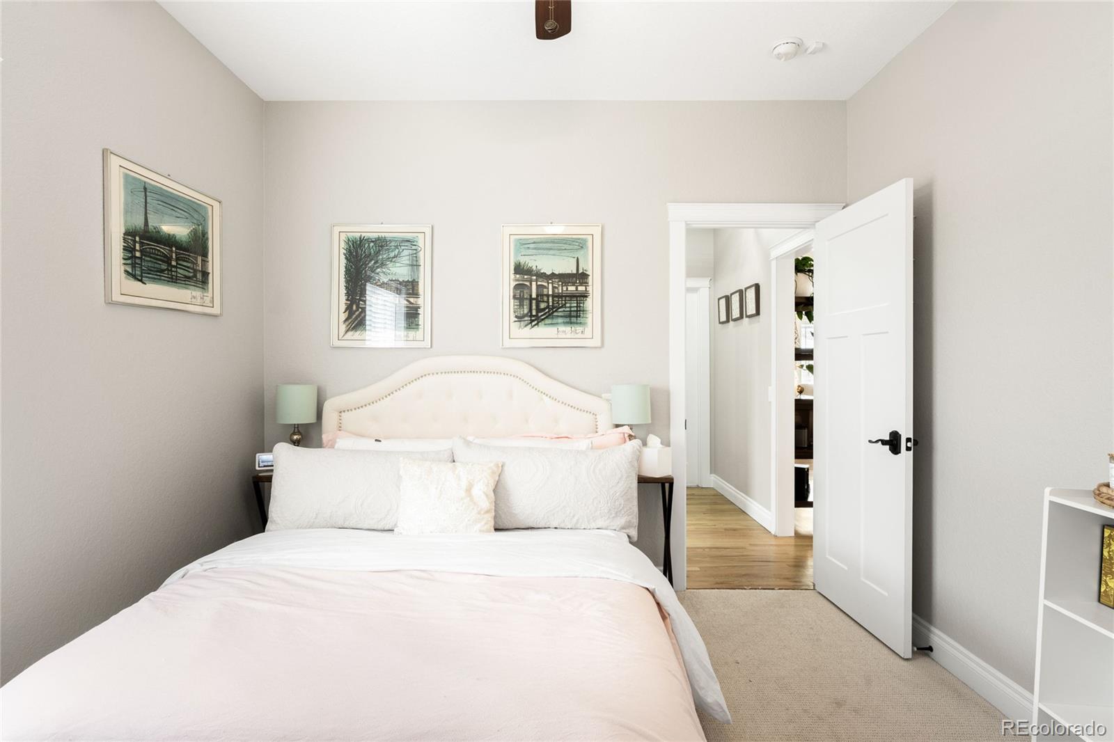 3017 Steele Street Denver, CO 80205 - Photo 18 of 36 a bedroom with a bed and painting on the wall