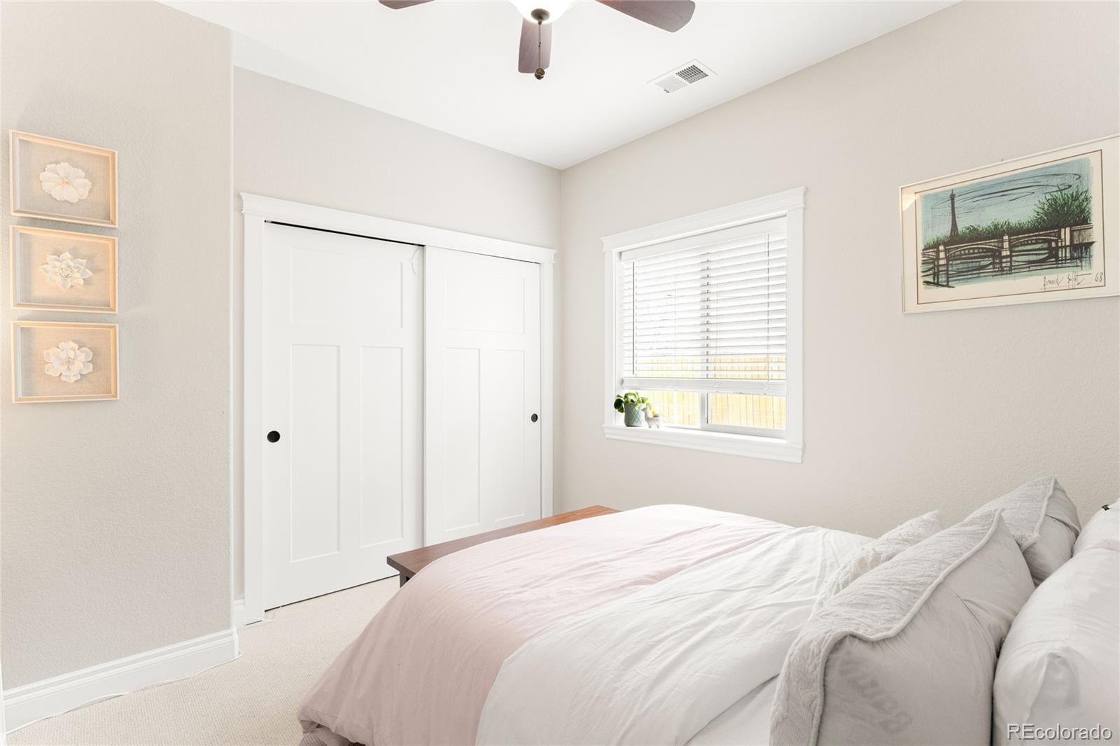 3017 Steele Street Denver, CO 80205 - Photo 19 of 36 a bedroom with a bed and a window