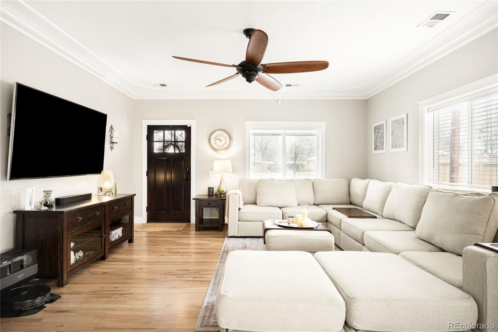 3017 Steele Street Denver, CO 80205 - Photo 2 of 36 a living room with furniture and a flat screen tv