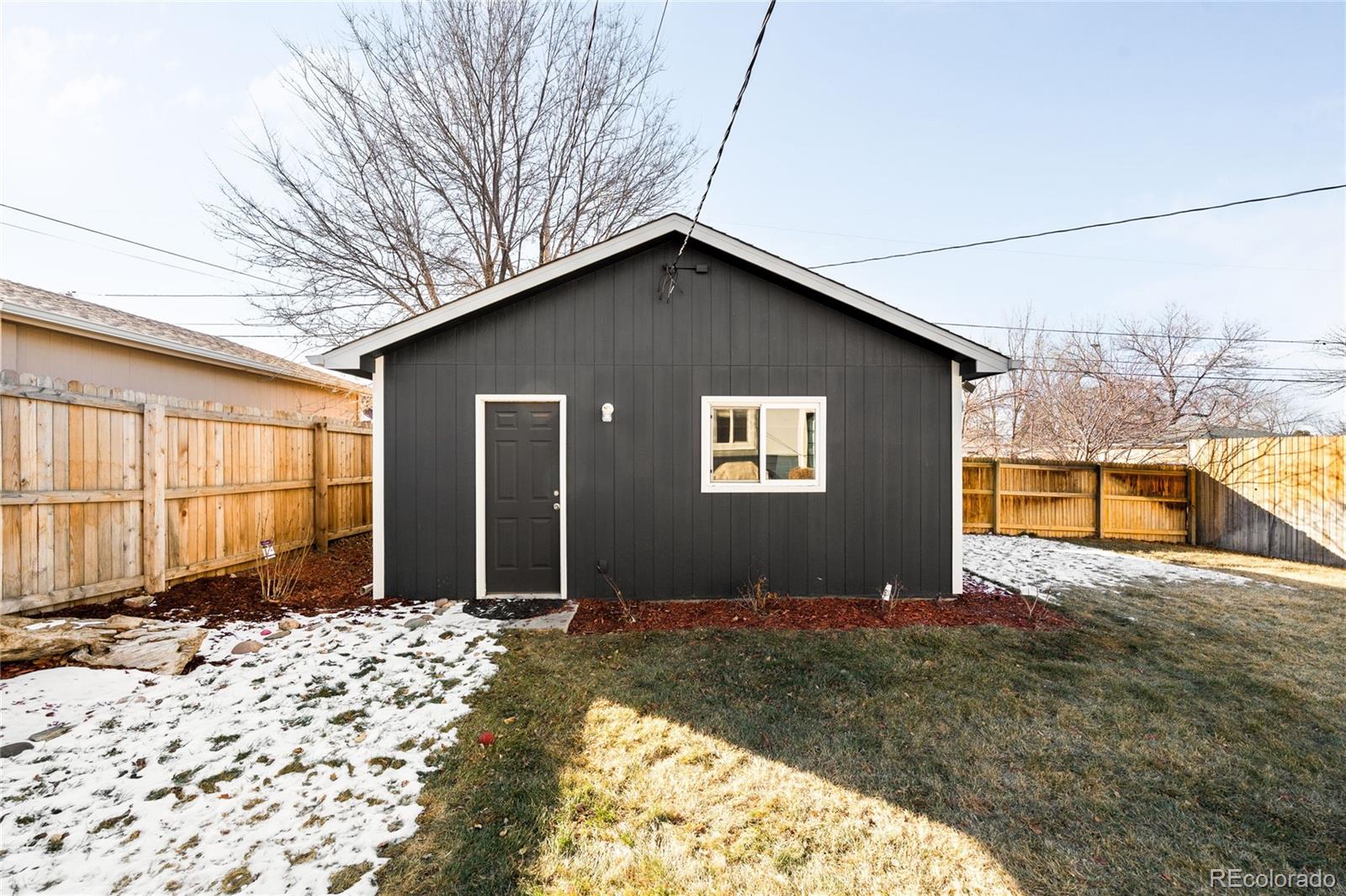 3017 Steele Street Denver, CO 80205 - Photo 31 of 36 a view of a house with a yard