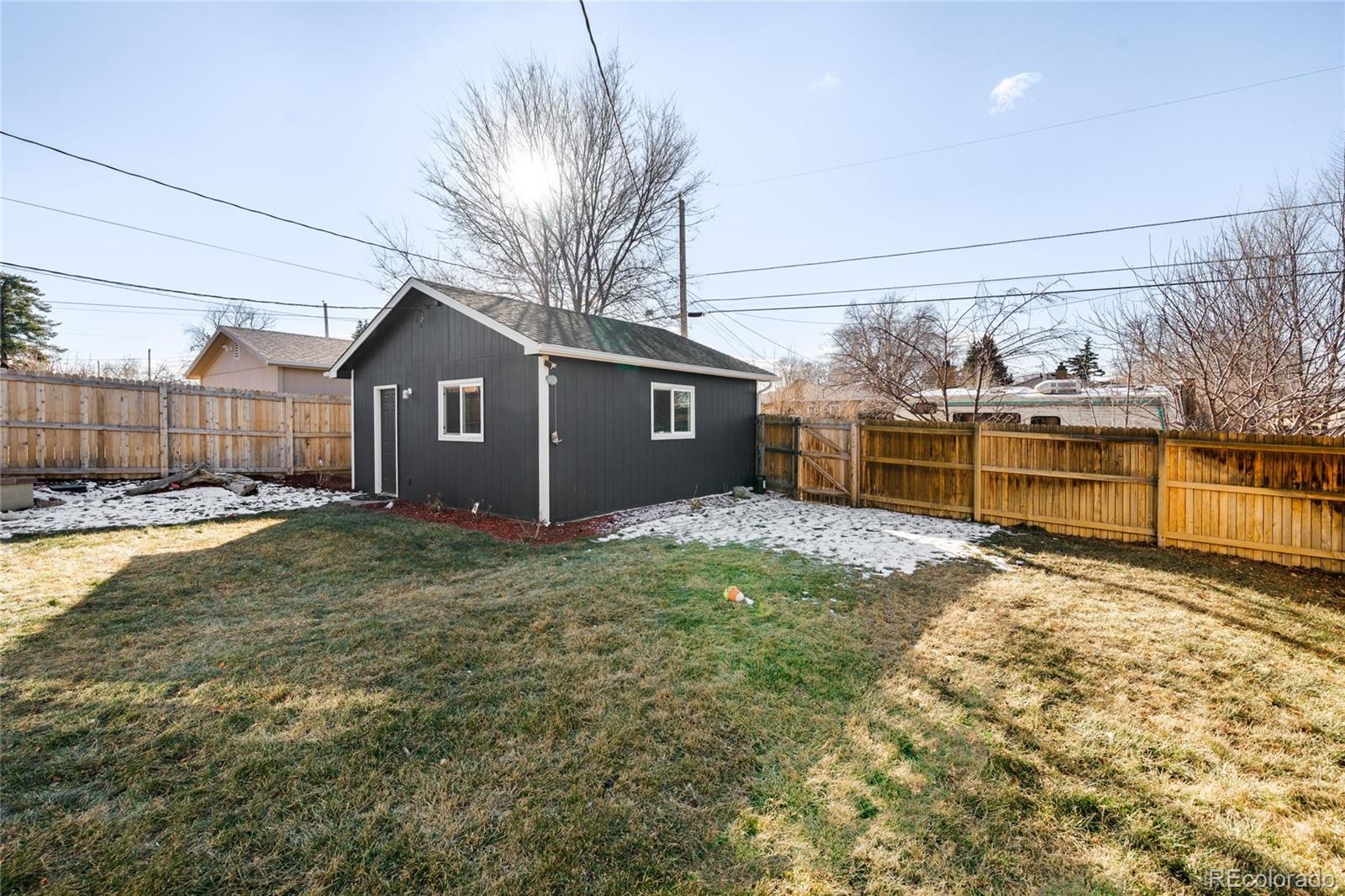 3017 Steele Street Denver, CO 80205 - Photo 32 of 36 a view of a house with a yard and garage