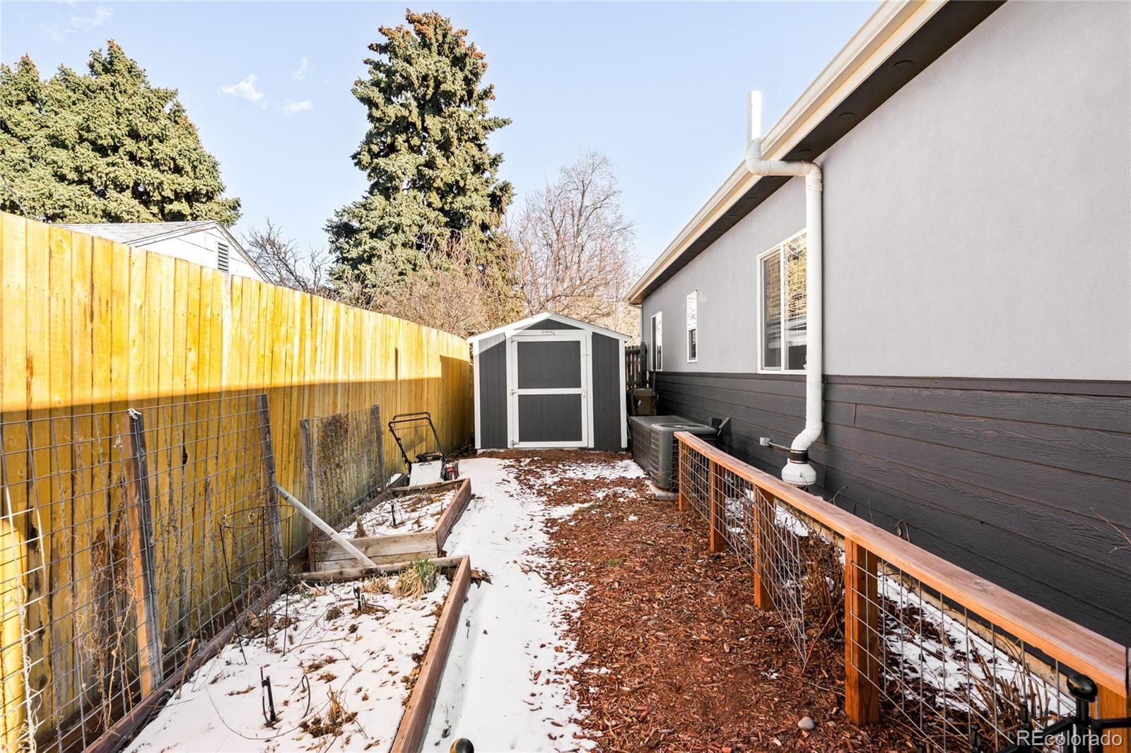 3017 Steele Street Denver, CO 80205 - Photo 33 of 36 a balcony view with two large trees and wooden fence