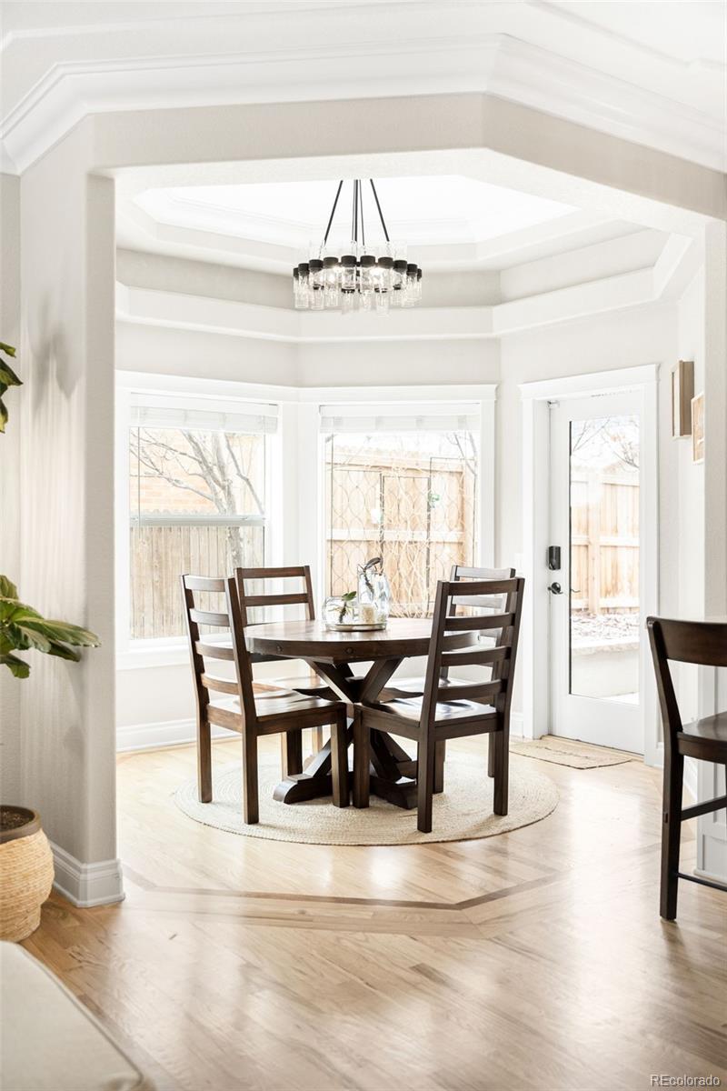 3017 Steele Street Denver, CO 80205 - Photo 8 of 36 a view of a dining room with furniture and wooden floor