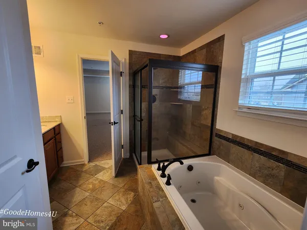 a bathroom with a bathtub and a shower