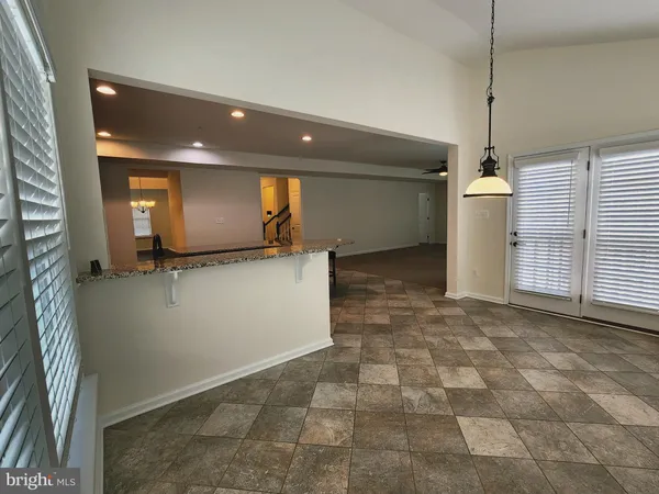 a view of a hallway with a kitchen