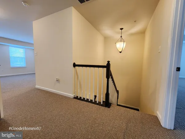 a view of a hallway with staircase