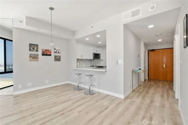 a view of kitchen with cabinets and wooden floor