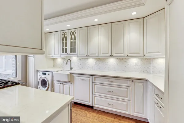 a kitchen with white cabinets and a sink