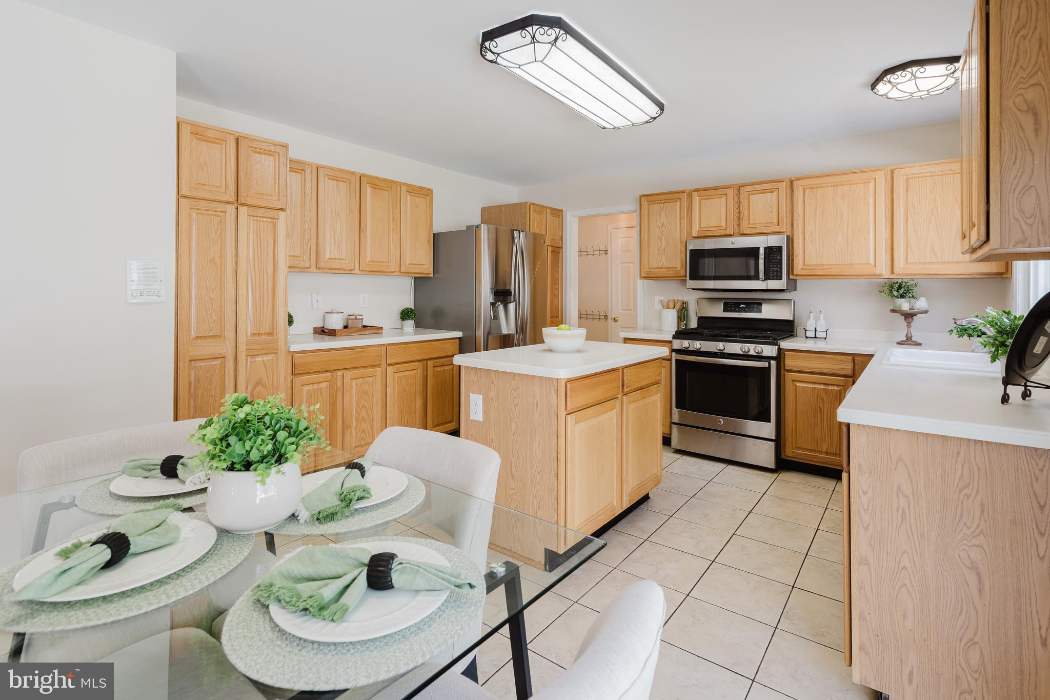 33 Hummingbird Lane Newark, DE 19711 - Photo 21 of 61 a kitchen with stainless steel appliances a stove a sink a stove a dining table and chairs