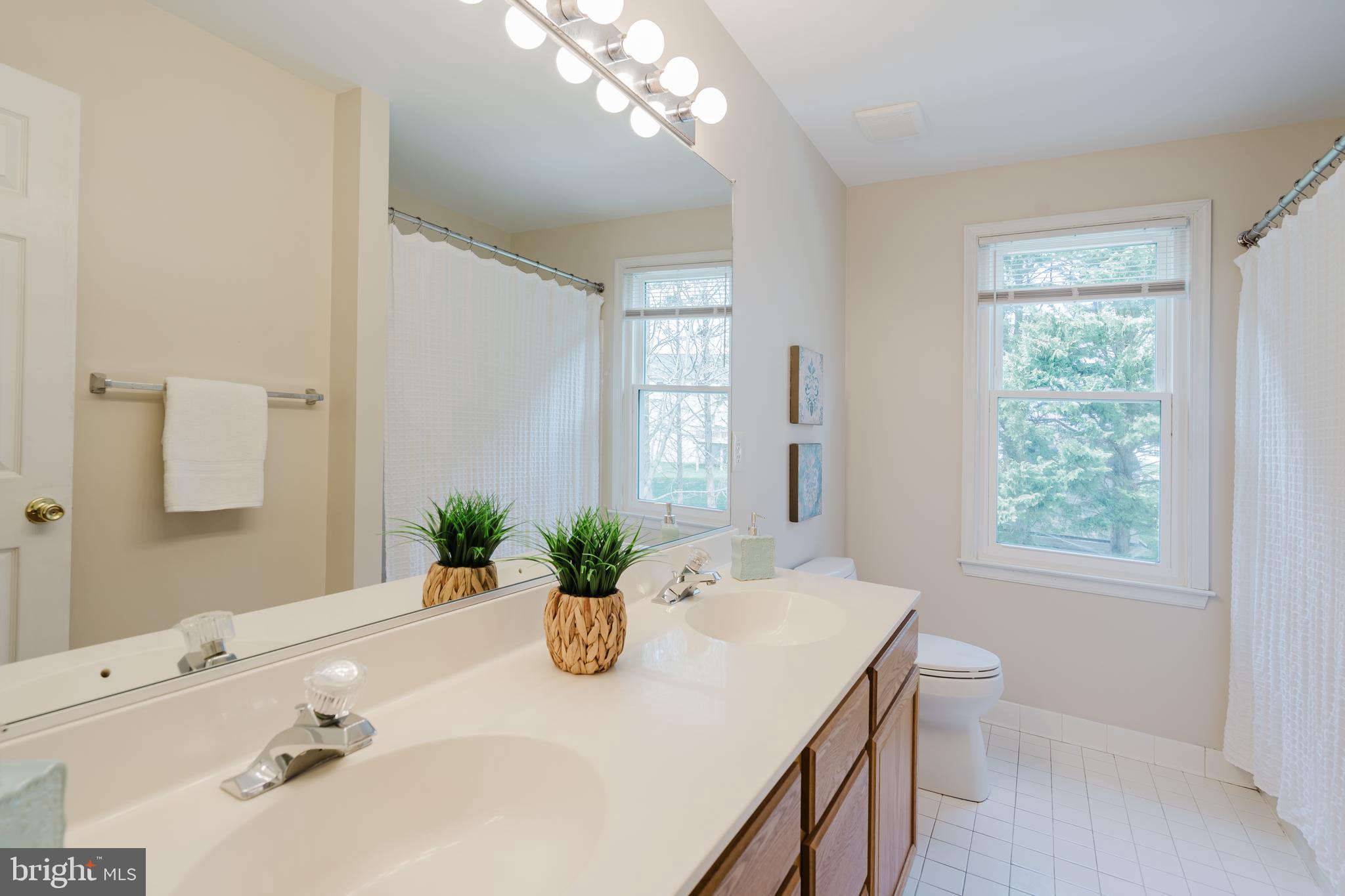 33 Hummingbird Lane Newark, DE 19711 - Photo 38 of 61 a bathroom with a granite countertop sink a toilet and a mirror