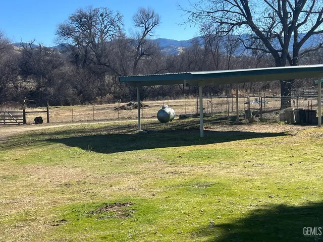 a swimming pool with outdoor seating and yard