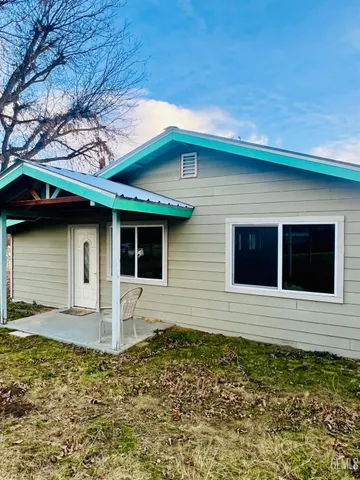 a backyard of a house with large trees