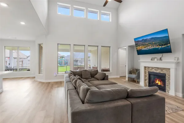 a living room with furniture a flat screen tv and a fireplace