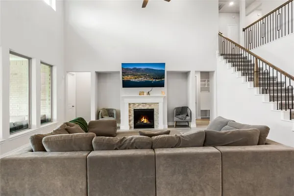 a living room with furniture a fireplace and a flat screen tv