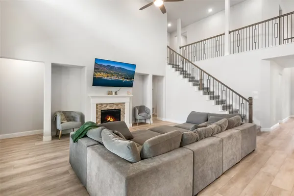 a living room with furniture a fireplace and a flat screen tv
