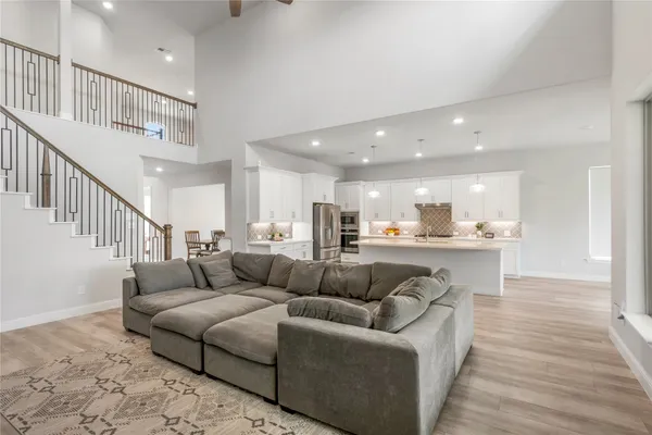 a living room with furniture and kitchen view