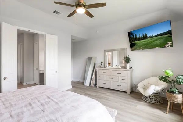 a bedroom with a bed and a flat screen tv