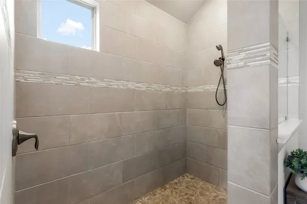 a bathroom with a glass shower door