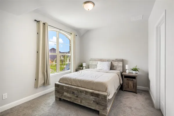 a bedroom with a bed and a window