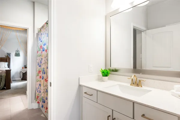 a bathroom with a granite countertop sink a mirror and a shower