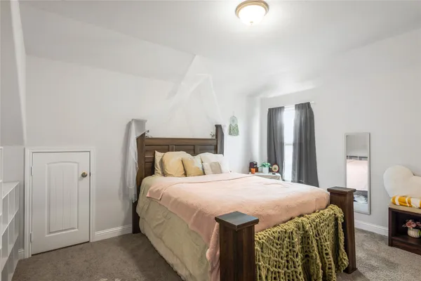 a bedroom with a bed and a dresser