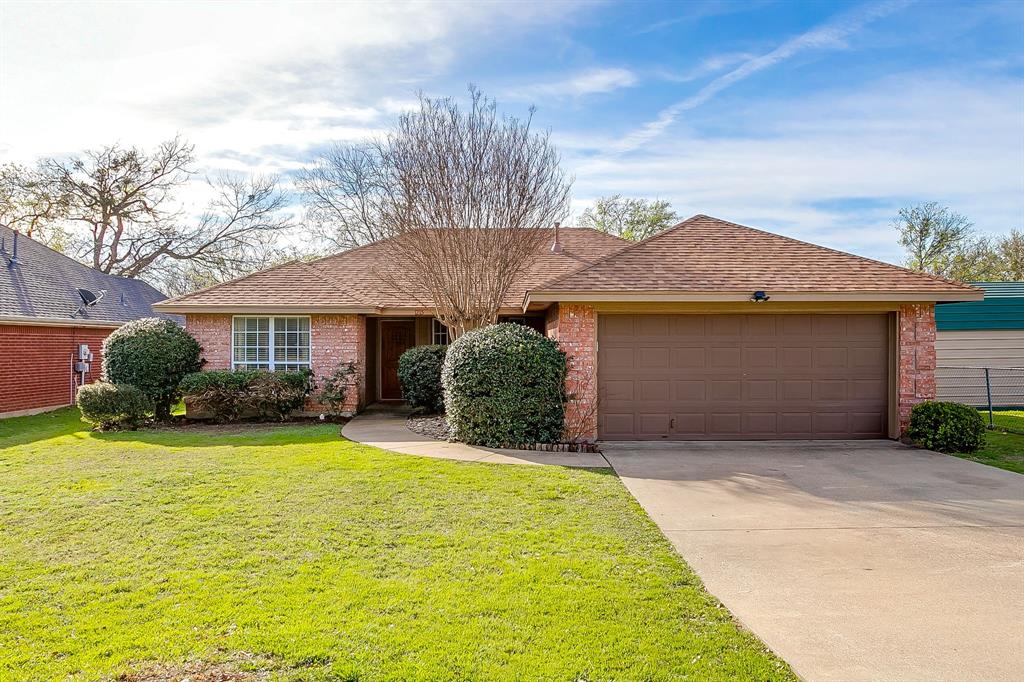 1215 Davis Street Cleburne, TX 76033 - Photo 1 of 1 a front view of a house with a yard and garage