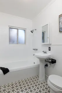 a bathroom with a sink a toilet and bathtub