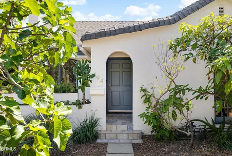 a couple of potted plants in front of door