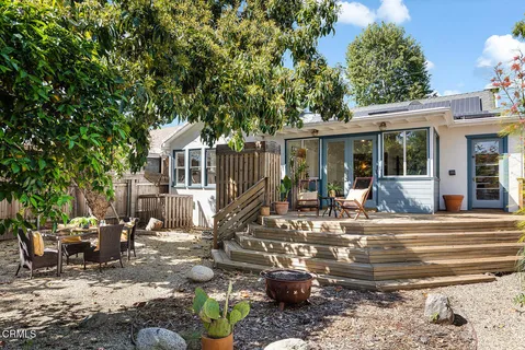 a view of a house with backyard porch and sitting area